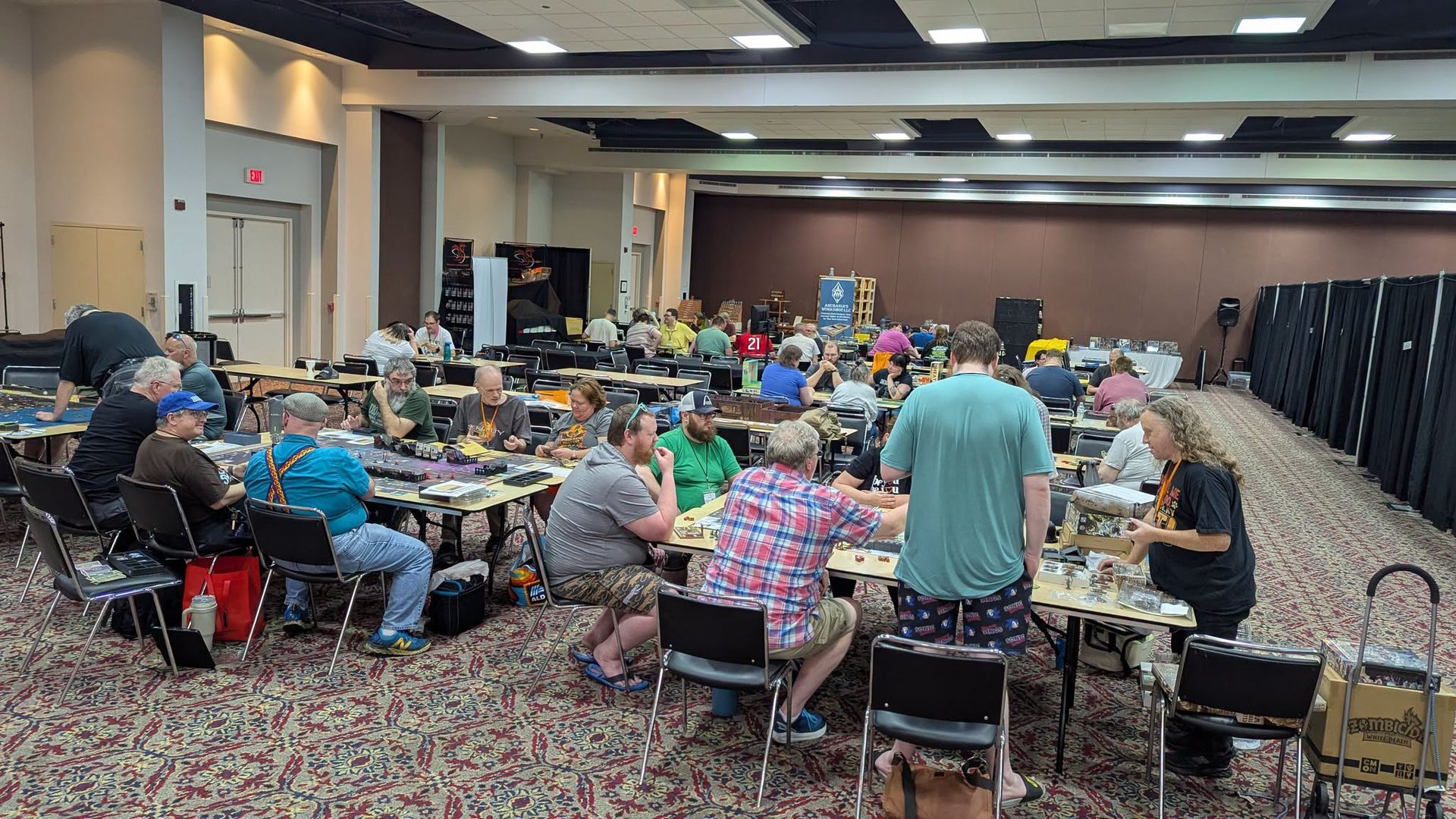 DieCon convention hall filled with tabletop gamers, vendors, and demo tables.